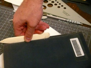 Use the bone folder to work the groove.